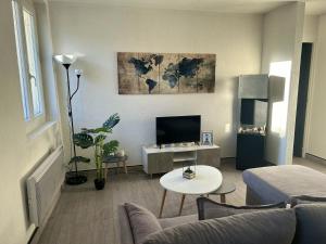 - un salon avec un canapé et une télévision dans l'établissement Appartement de 2 chambres avec wifi a Luzenac a 8 km des pistes, à Luzenac