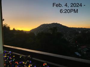 a view of a sunset from a balcony of a city at Courtyards Peak-Corner Pinestay - at Goshenland Baguio in Baguio