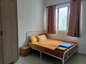 a small bed in a room with a window at NurAz Residensi Adelia2, Bangi Avenue, Free wifi, Pool in Kajang