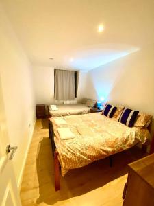 a bedroom with two beds and a window at One Bedroom Apartment in Ealing Broadway London in Ealing