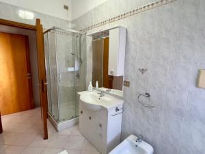a bathroom with a sink and a shower and a toilet at Casa di Jack I.U.N. R6217 in Quartu SantʼElena +35 photos