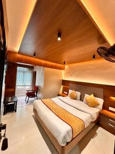 ein Schlafzimmer mit einem großen Bett in einem Zimmer in der Unterkunft Hotel City Palace in Udagamandalam
