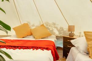 1 dormitorio con 1 cama con almohadas de color naranja y blanco en Ganzo - Tuscany Retreat en Massarosa