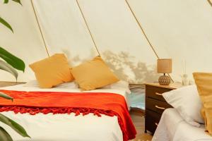 a bedroom with a bed with orange and white pillows at Ganzo - Tuscany Retreat in Massarosa