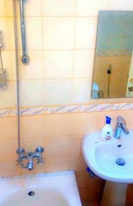 a bathroom with a sink and a mirror at Alwaha-Appartement in Riyadh