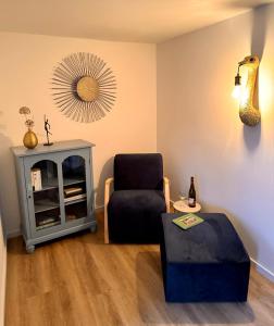 a living room with a chair and a mirror at HEIMATliebe Ferienhaus für 4 in Blankenhain