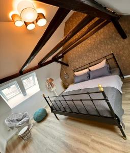 a bedroom with a large bed in a attic at HEIMATliebe Ferienhaus für 4 in Blankenhain