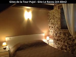 a bedroom with a bed with two lights on it at Les Gîtes de la Tour Pujol in Argelès-sur-Mer