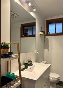 a bathroom with a sink and a mirror at OwLHouse on Island in Cowes