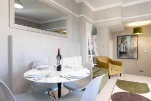 uma sala de jantar branca com uma mesa e cadeiras brancas em Central, Stunning 2 Bed Apartment with Parking! em Cambridge