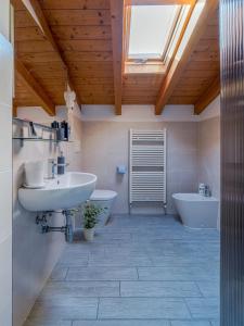 a bathroom with a sink and two toilets and a skylight at House Sabbioneta in Sabbioneta +26 photos
