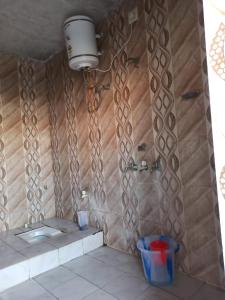 a bathroom with a shower with a toilet and a sink at Ashu Homestay in Ayodhya