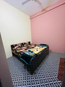 a bedroom with a bed in a room at Ashu Homestay in Ayodhya