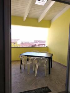 a dining room with a table and two chairs at La casa del sole - casa vacanze in Uri +10 photos