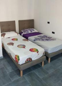 Säng eller sängar i ett rum på La casa del sole - casa vacanze