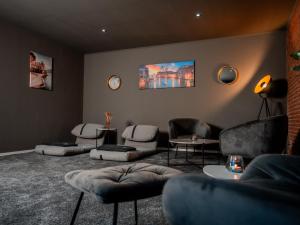 a waiting room with couches and chairs at Hotel We Wellness in Adendorf