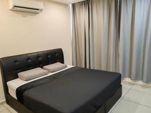 a bed with two pillows on it in a room at HOTEL APOLLO KAMPUNG BENGGALI in Butterworth