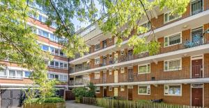 an apartment building with balconies and a courtyard at Large and bright one bedroom apartment with free parking! in London