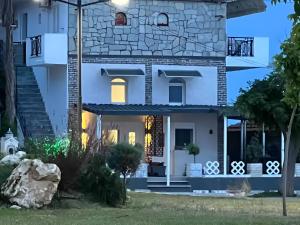 a house with the front entrance at night at House by the sea suite 2 in Skála Foúrkas