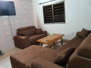 a living room with a couch and a table at Lumen Palace Kpalime Ville in Palimé