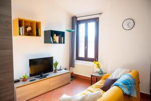 a living room with a couch and a tv at Ferrara center - Luxury apartment in medieval area with Wi-Fi in Ferrara