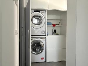 a laundry room with two washer and dryer at Casa Ciliegi 3 in Marostica
