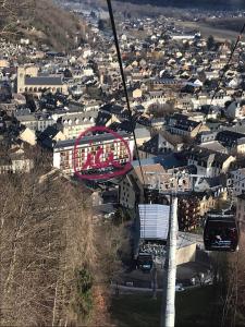 una gondola che vola sopra una città con una città di Appartement 2 à 4 personnes Luchon centre a Luchon