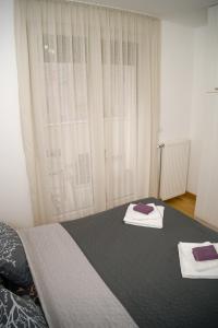 Postel nebo postele na pokoji v ubytování Apartment Infinity