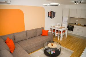 a living room with a couch and a table at Apartment Infinity in Kruševac