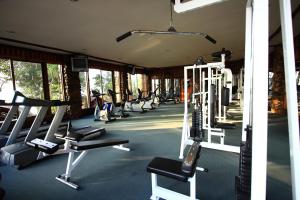a gym with a row of treadms and machines at Phu Pha Nam Resort in Dan Sai