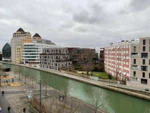 a river in a city with buildings and buildings at Studio number 10 in Pantin