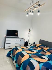 a bedroom with three beds and a television in it at Orizzonte 5 Terre, VIALE ITALIA 221 - Partenza battelli 5 Terre in La Spezia