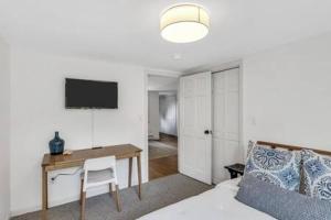 a living room with a desk and a room with a bed at Cape Cod Retreat with Beach Access in Falmouth