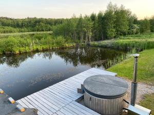 a wooden dock in the middle of a lake at Mazurski Domek - Wake Up Home Ogonki in Ogonki