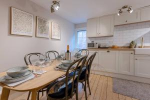 a kitchen and dining room with a wooden table and chairs at Pass the Keys Juno Apartment In the centre of historic Ludlow in Ludlow