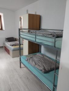 a room with three bunk beds and a refrigerator at Casa Antonia in Timişoara