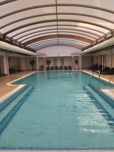 a large indoor swimming pool with a ceiling at Melange Apartman *** in Zalakaros