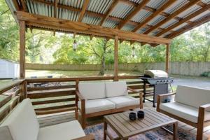a screened in porch with chairs and a grill at The Pennington - Roomy Dog-friendly Home with Yard in Nashville