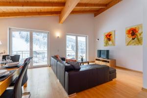 a living room with a couch and a table at Schmittenhöhe Lodge in Zell am See