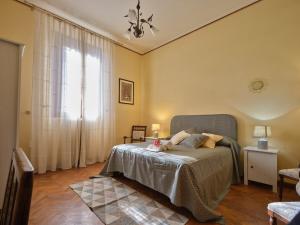 a bedroom with a bed and a large window at Villa Socini in Siena