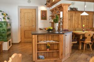 a kitchen with a wooden island and a table at Bauernhof Krahlehenhof in Filzmoos