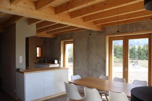 een keuken en eetkamer met een tafel en stoelen bij chalet montagne la lupina in Les Orres