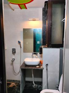 a bathroom with a sink and a mirror at Hotel Prem Shanti Inn in Dhaulpur