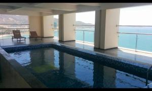 a swimming pool in a building with a view of the water at Lenid Ocean View Hotel in Nha Trang