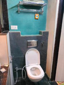 a small bathroom with a toilet in a stall at Hotel Prem Shanti Inn in Dhaulpur