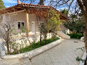 a house with a garden in front of it at Nefele - Athens Airport Home in Artemida