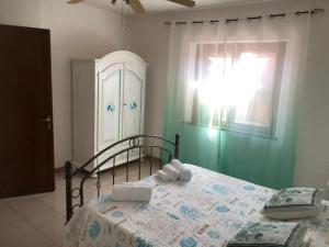 a bedroom with a bed with towels on it at Green Apartment in La Maddalena