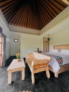 乌布Widya Luxury House的一间卧室配有一张床和两张桌子