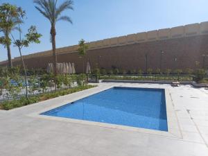 a swimming pool in front of a building at Alumia Marigold Suite 3BR Apt Pool Access in Cairo
