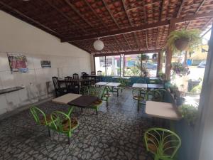 a restaurant with tables and chairs in a room at Pousada Santovo in Porto De Galinhas +26 photos
